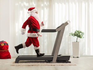 Santa is getting in his holiday running on a treadmill