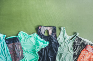 A selection of mostly green athletic clothing laid out 