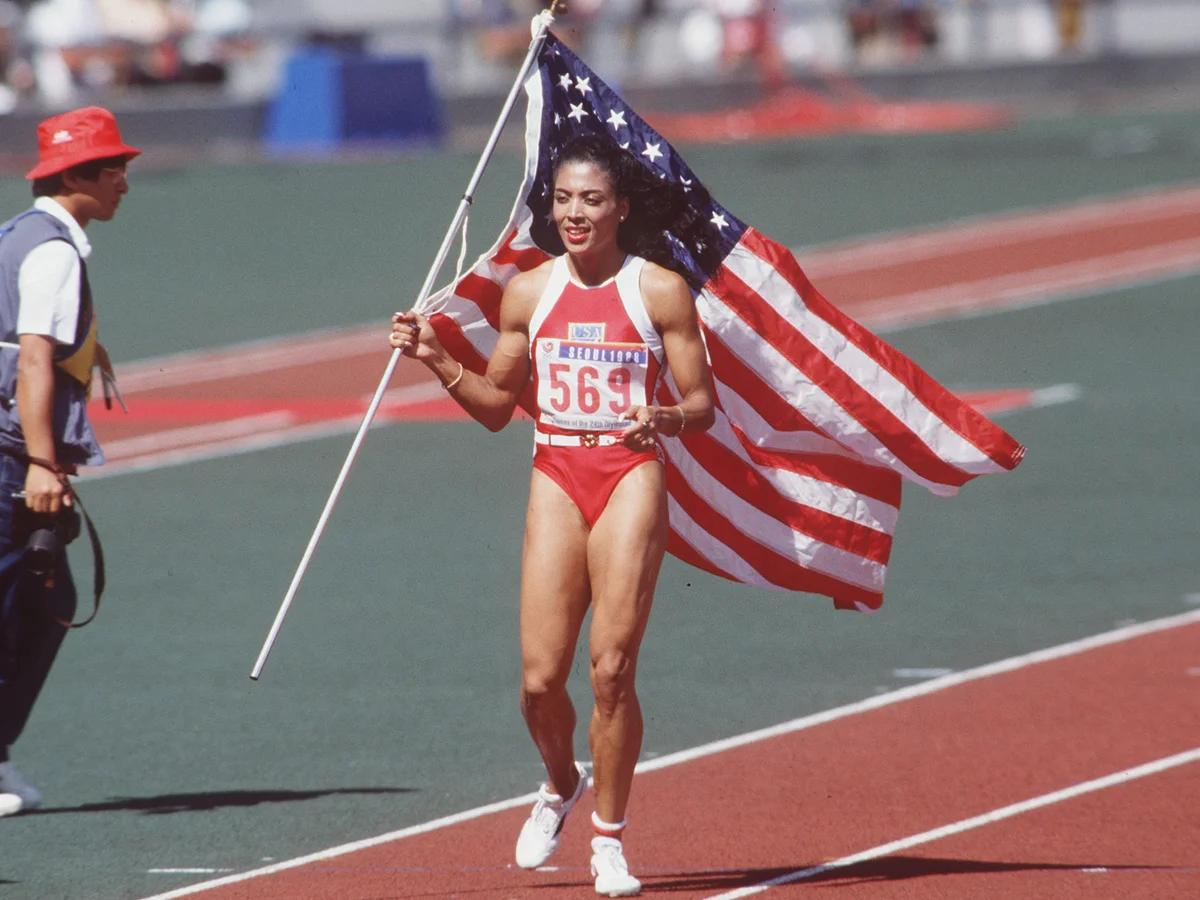 Florence Griffith Joyner carries US flag on track