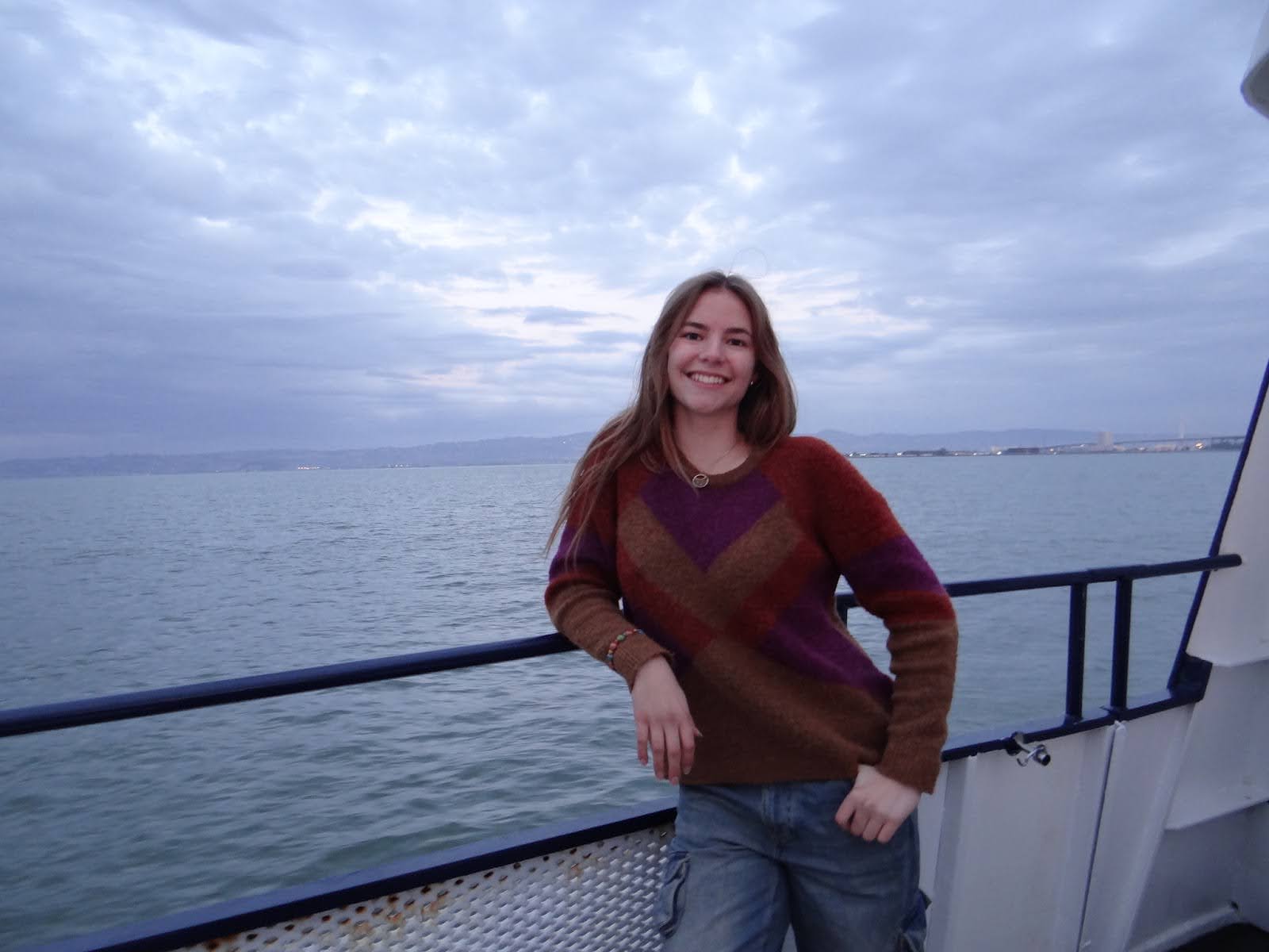 Annika Punz of Cal Running Club standing outdoors with a sunset view
