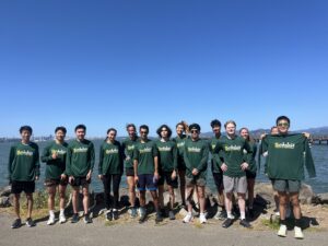 Cal Running Club members in Berkeley Half Marathon long sleeve shirts posing by the water