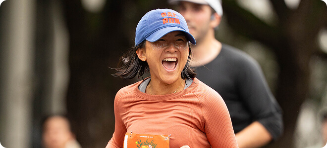 Runner in a blue hat smiling