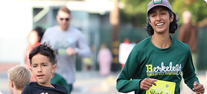 Parent and child running side by side in a Berkeley 1K Race